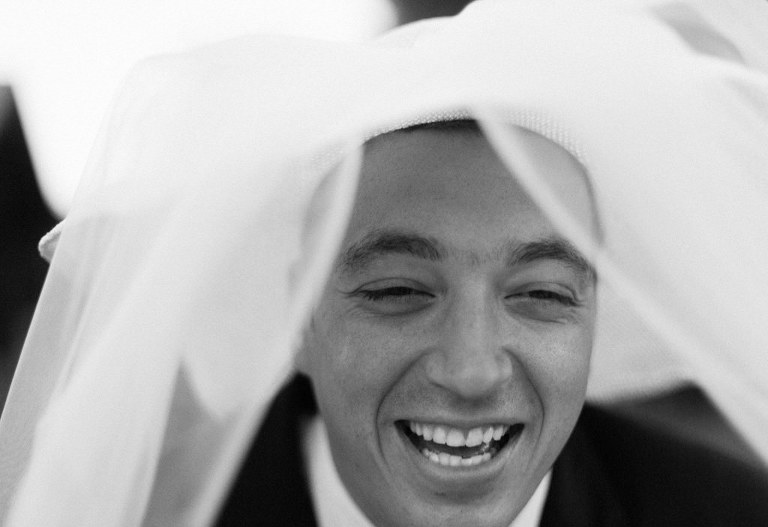 groom with hat smiling to camera