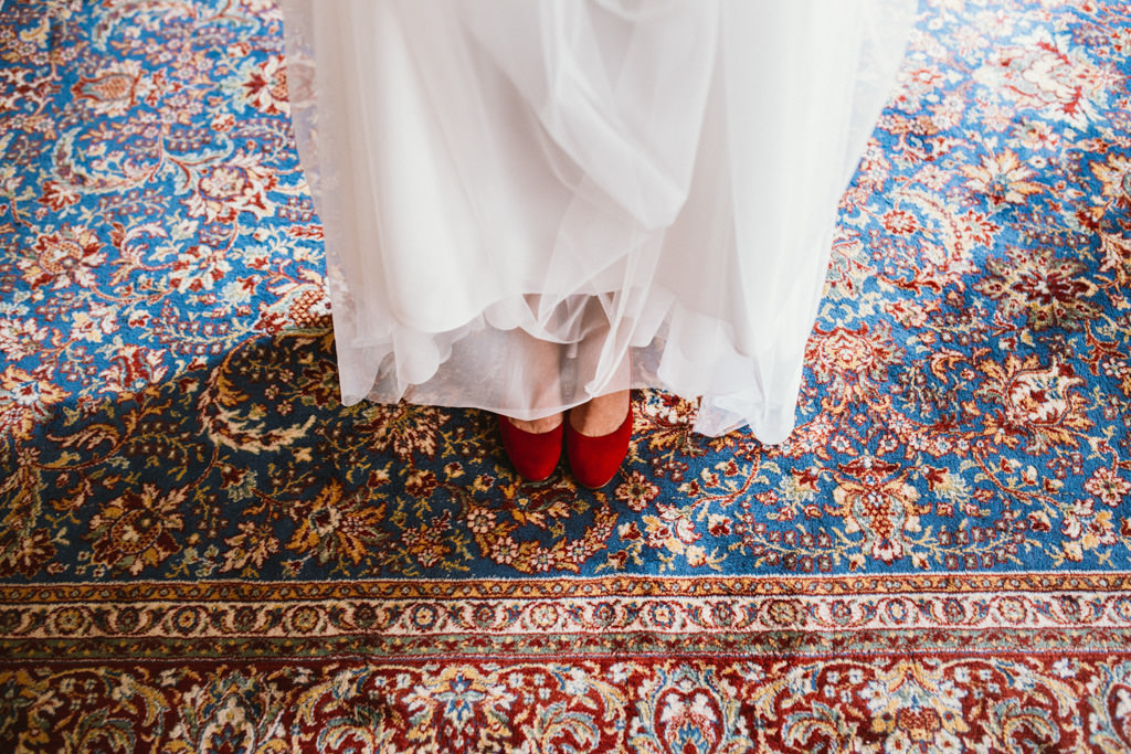 bride with her red wedding shoes