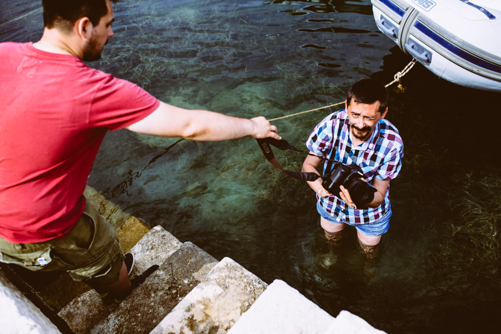 istria wedding photographer jumps in the sea to take photos of bride and groom